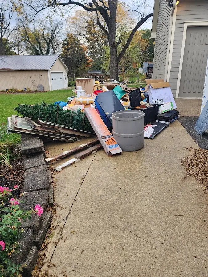 Dumpster being loaded with debris for Estate Cleanout Dumpster Rental in Webster